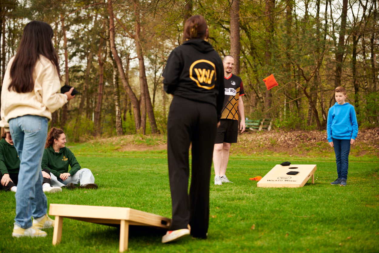 Friends playing cornhole